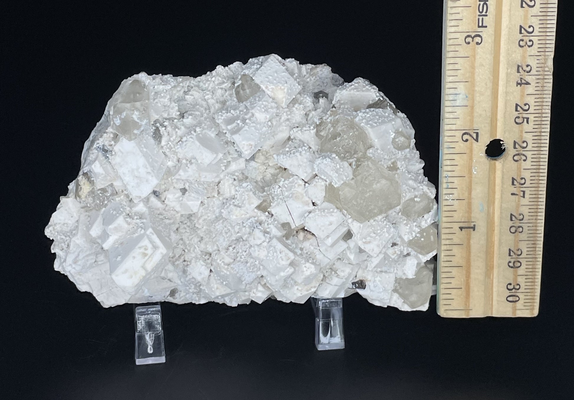 A close-up image of a mineral specimen featuring creamy Orthoclase crystals intergrown with clear quartz and dark tourmaline, showcasing a striking blend of textures and colors.