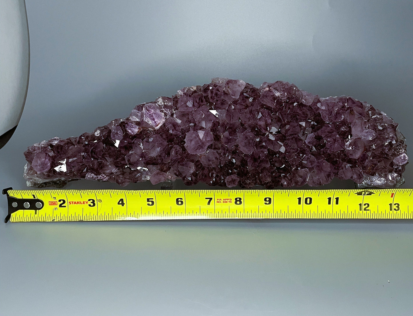 Amethyst cluster with brilliant hues of purple and various sizes of crystal formations.