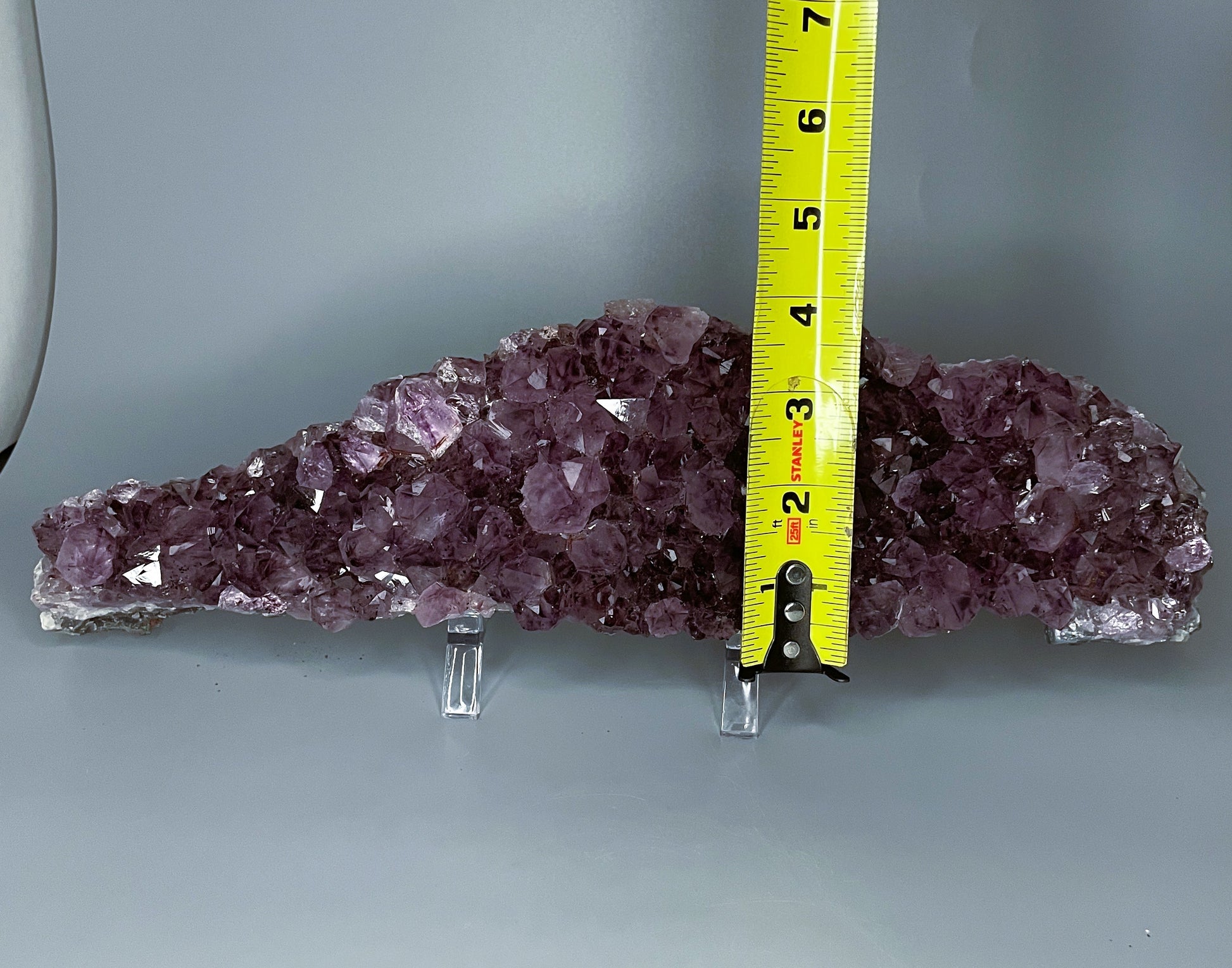 Amethyst cluster with brilliant hues of purple and various sizes of crystal formations.