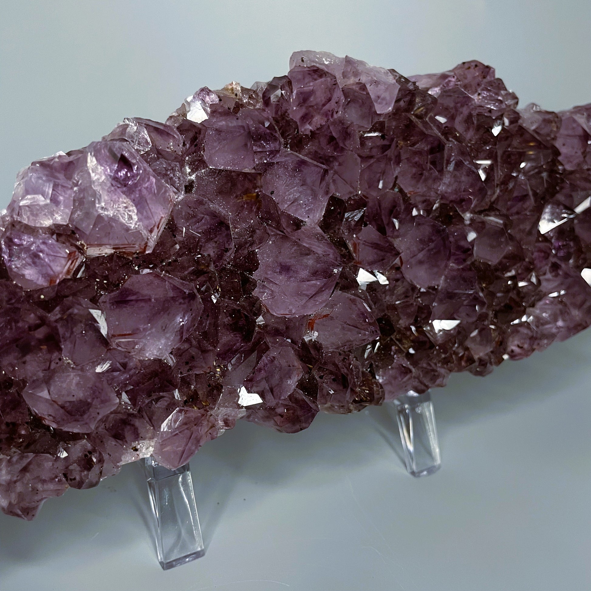 Amethyst cluster with brilliant hues of purple and various sizes of crystal formations.