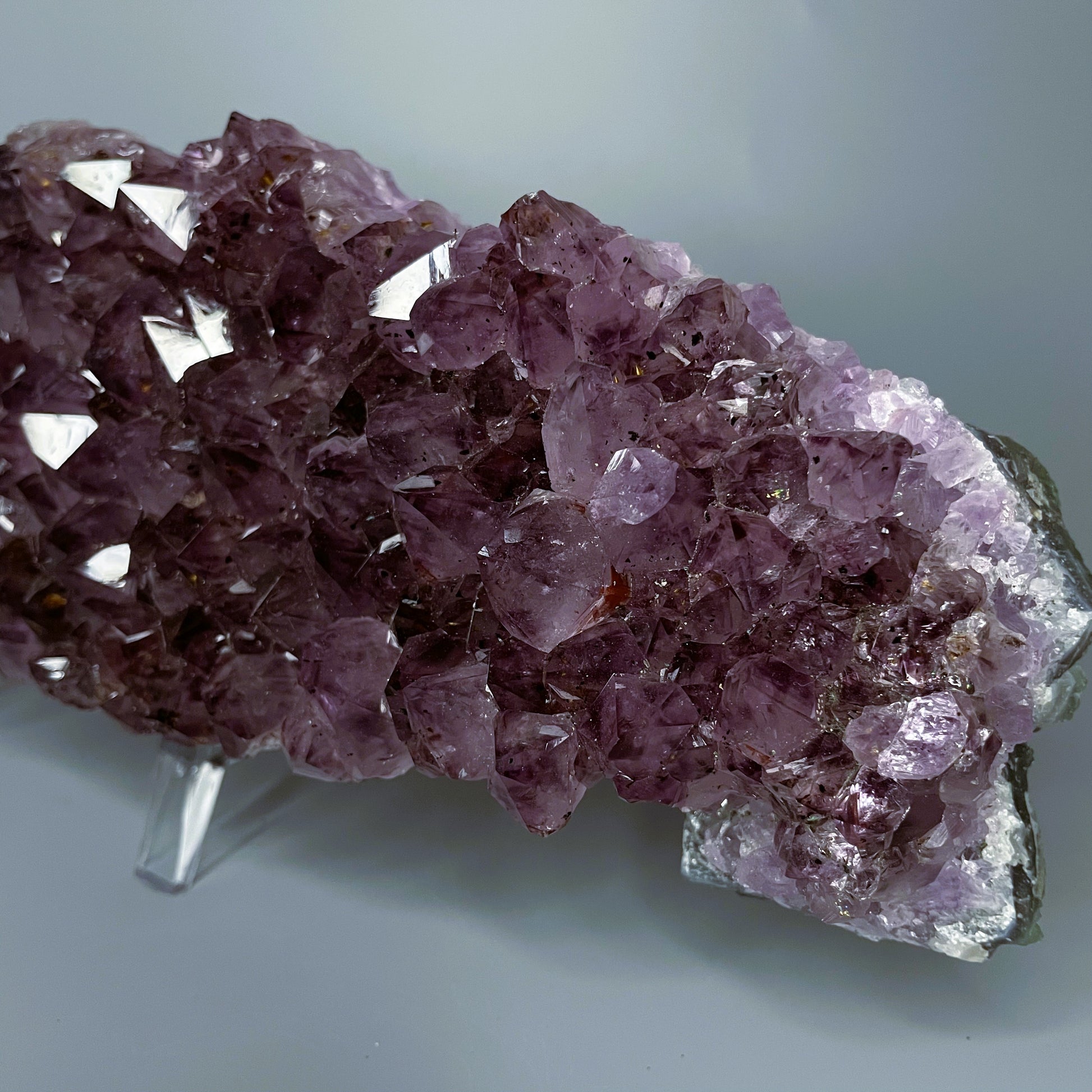 Amethyst cluster with brilliant hues of purple and various sizes of crystal formations.