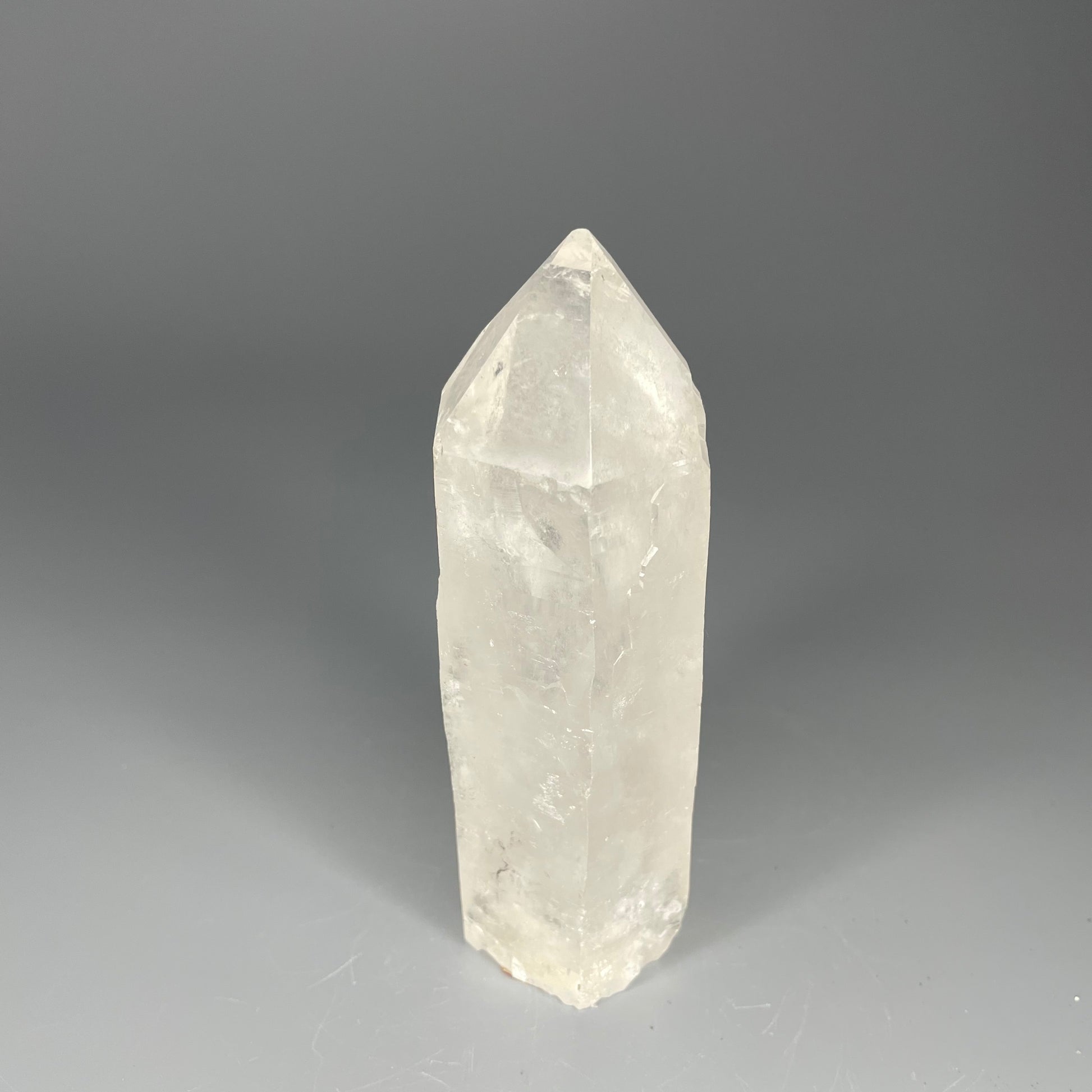 A 4.75-inch Clear Quartz double-point tower with a smooth, polished finish, standing upright against a neutral background.