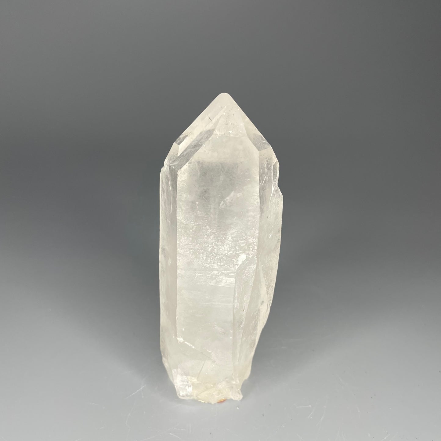 A 4.75-inch Clear Quartz double-point tower with a smooth, polished finish, standing upright against a neutral background.