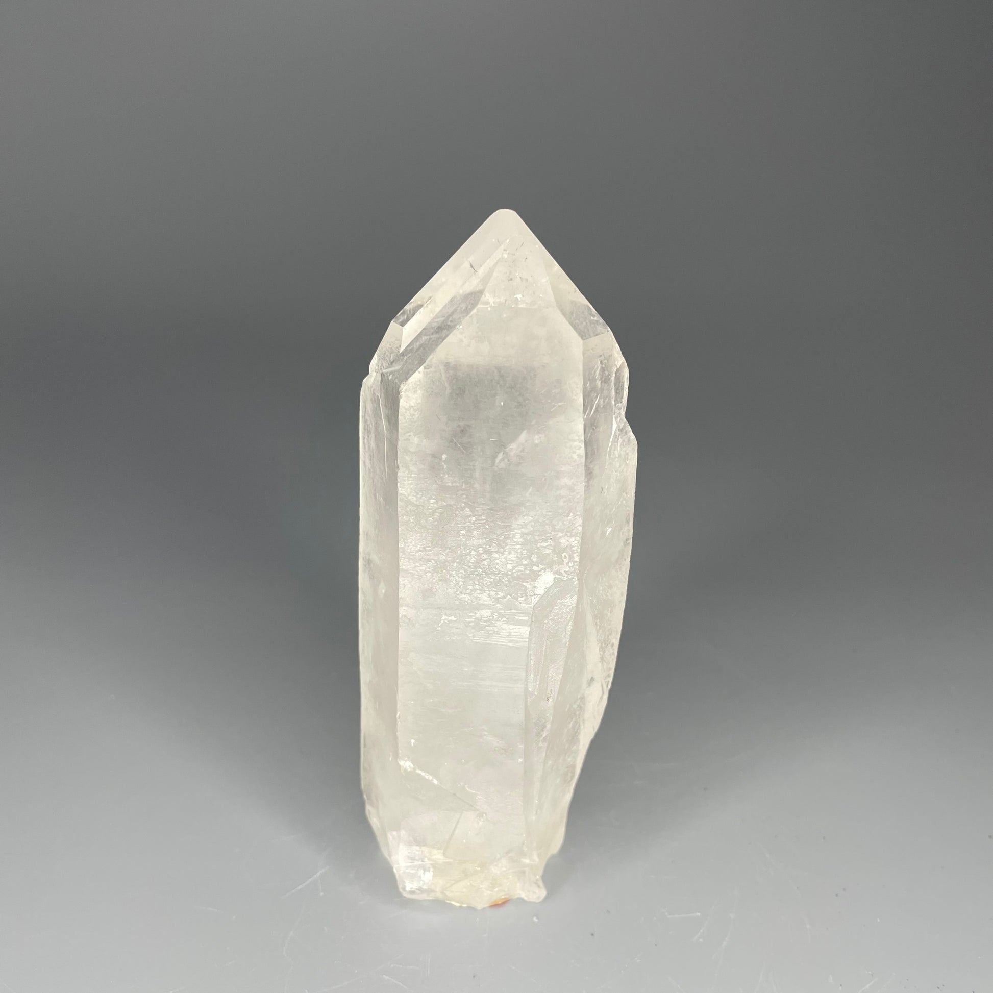 A 4.75-inch Clear Quartz double-point tower with a smooth, polished finish, standing upright against a neutral background.
