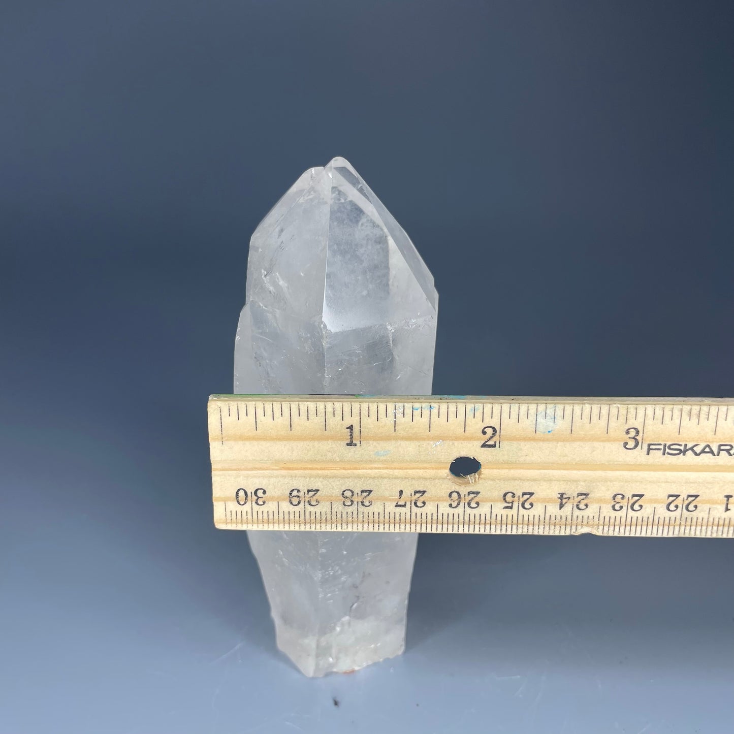 A 4.75-inch Clear Quartz double-point tower with a smooth, polished finish, standing upright against a neutral background.