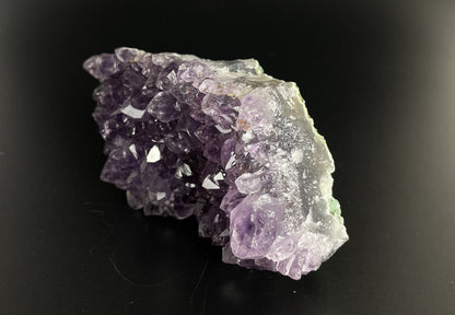 Amethyst cluster with brilliant hues of purple and various sizes of crystal formations.