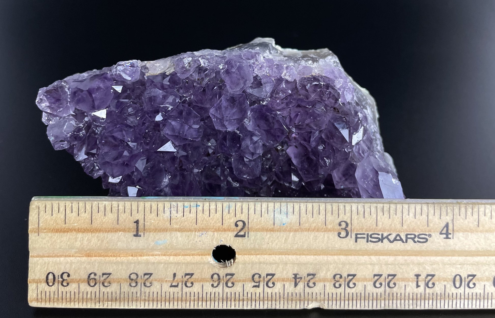 Amethyst cluster with brilliant hues of purple and various sizes of crystal formations.