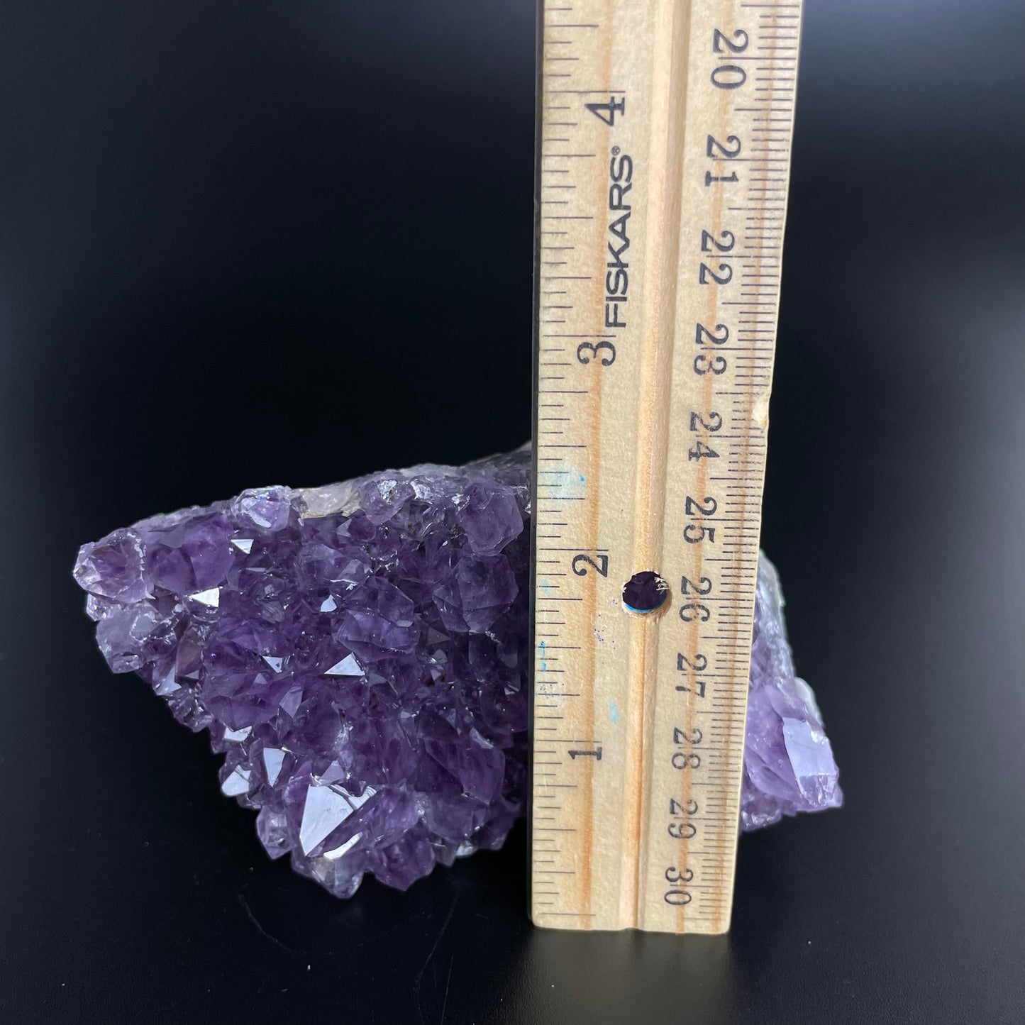 Amethyst cluster with brilliant hues of purple and various sizes of crystal formations.