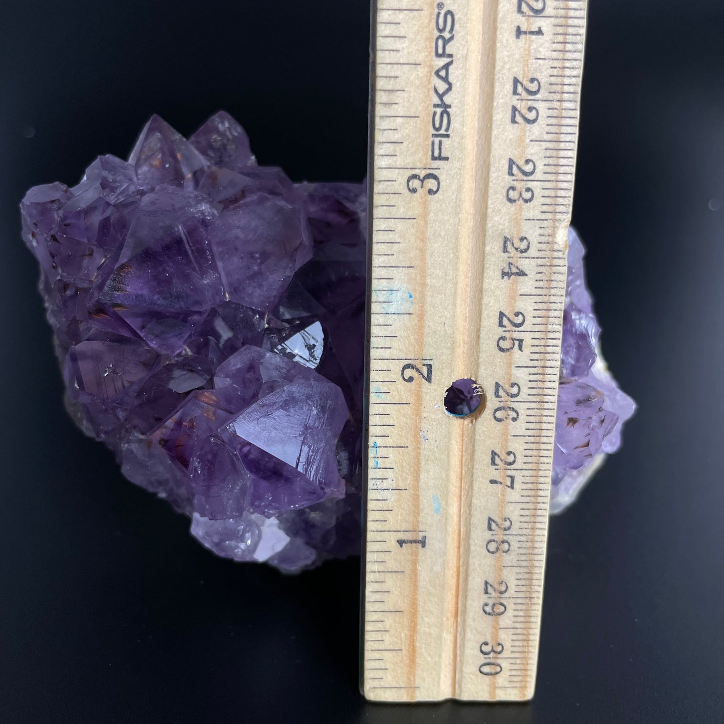 Amethyst cluster with brilliant hues of purple and various sizes of crystal formations.