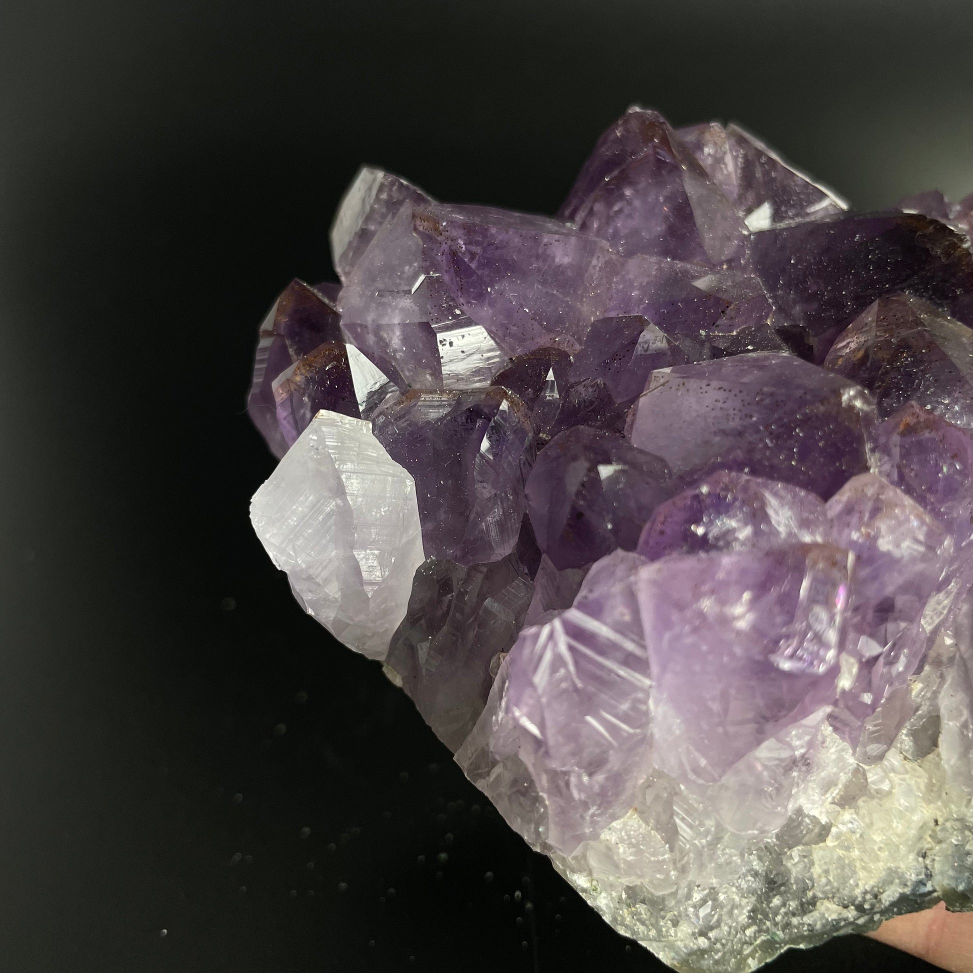 Amethyst cluster with brilliant hues of purple and various sizes of crystal formations.