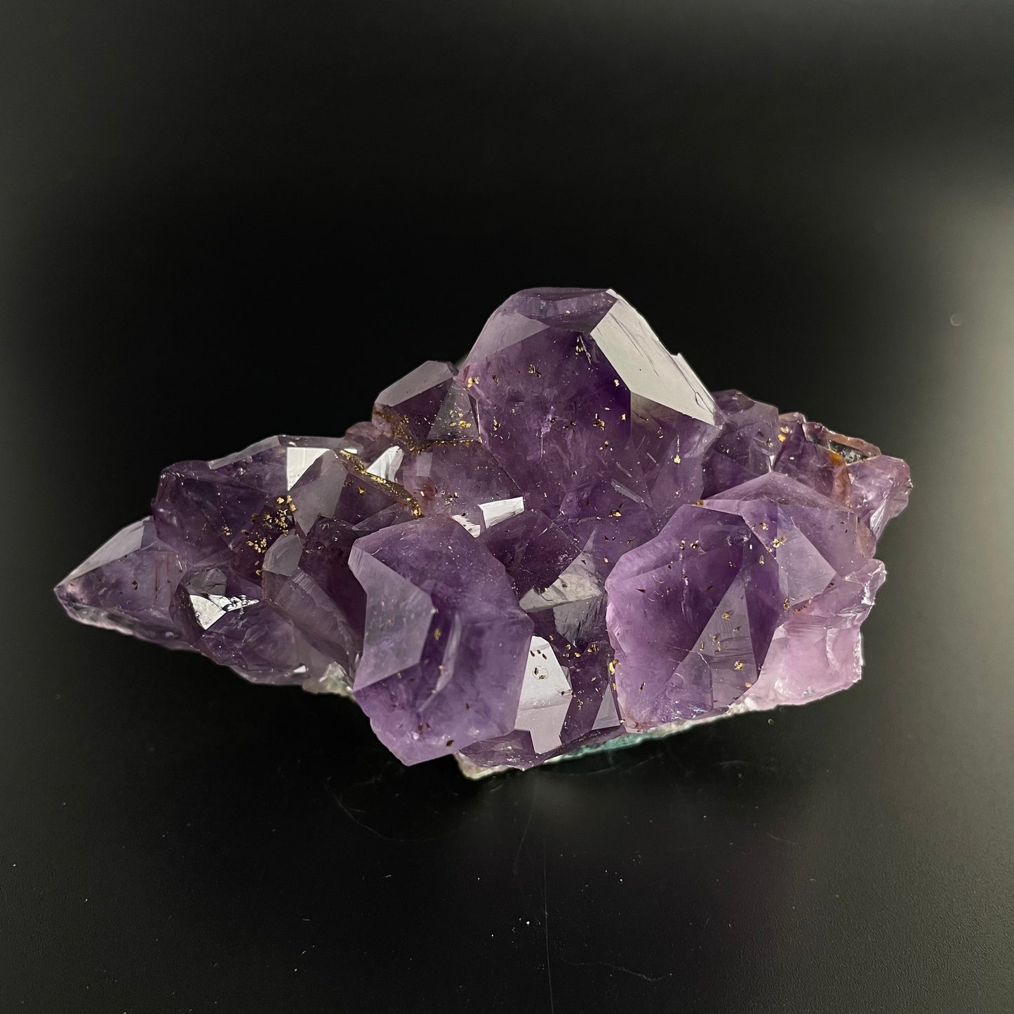 Amethyst cluster with brilliant hues of purple and various sizes of crystal formations.