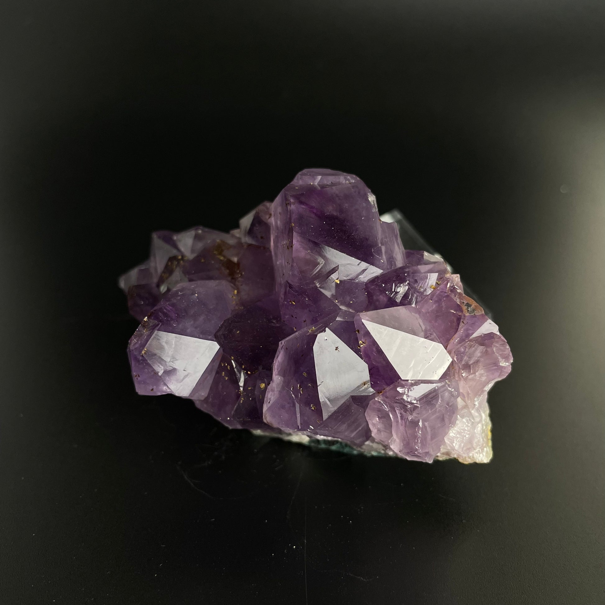 Amethyst cluster with brilliant hues of purple and various sizes of crystal formations.