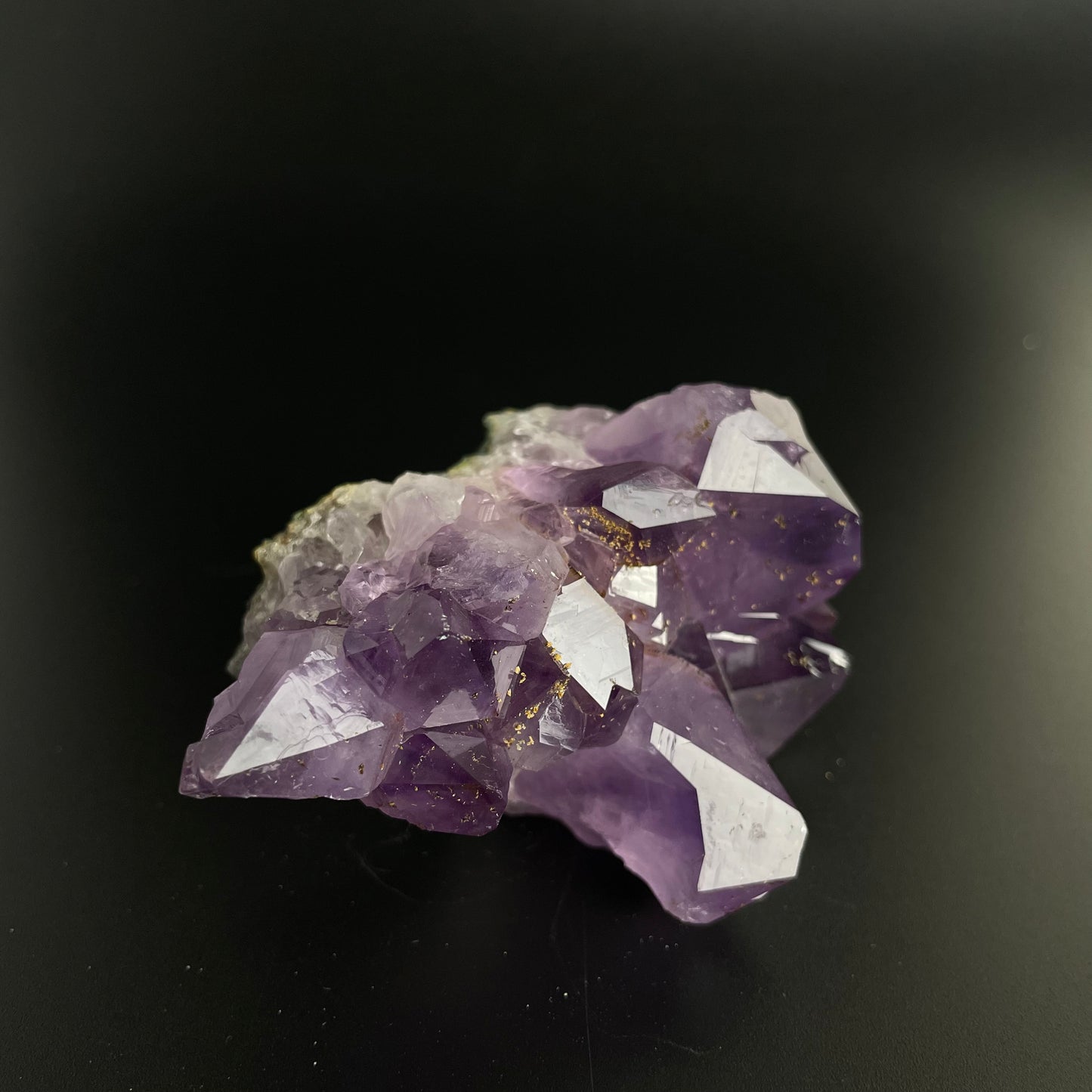 Amethyst cluster with brilliant hues of purple and various sizes of crystal formations.