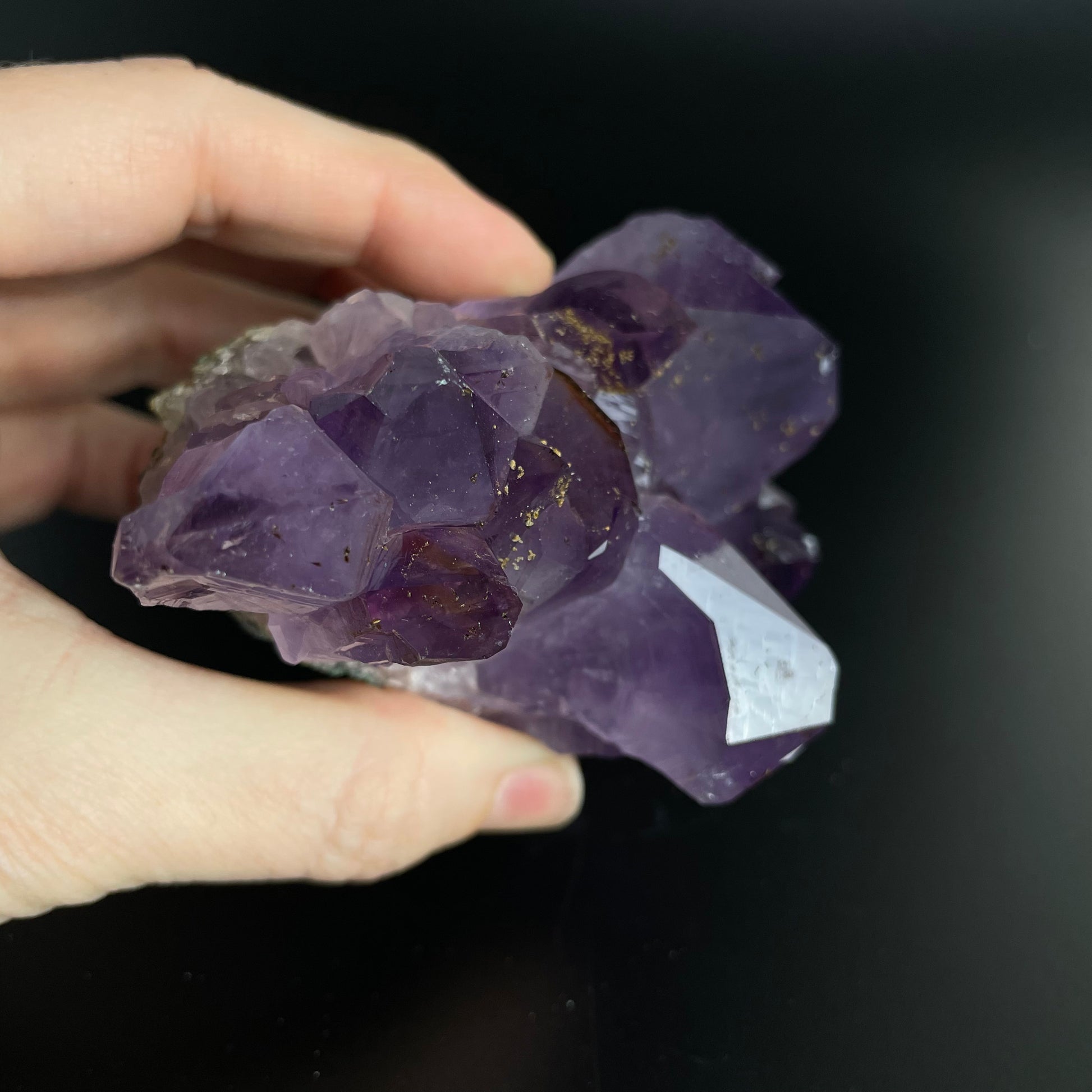 Amethyst cluster with brilliant hues of purple and various sizes of crystal formations.