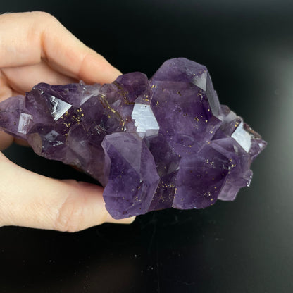 Amethyst cluster with brilliant hues of purple and various sizes of crystal formations.