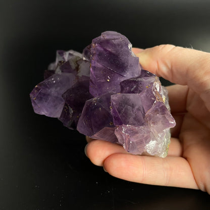 Amethyst cluster with brilliant hues of purple and various sizes of crystal formations.