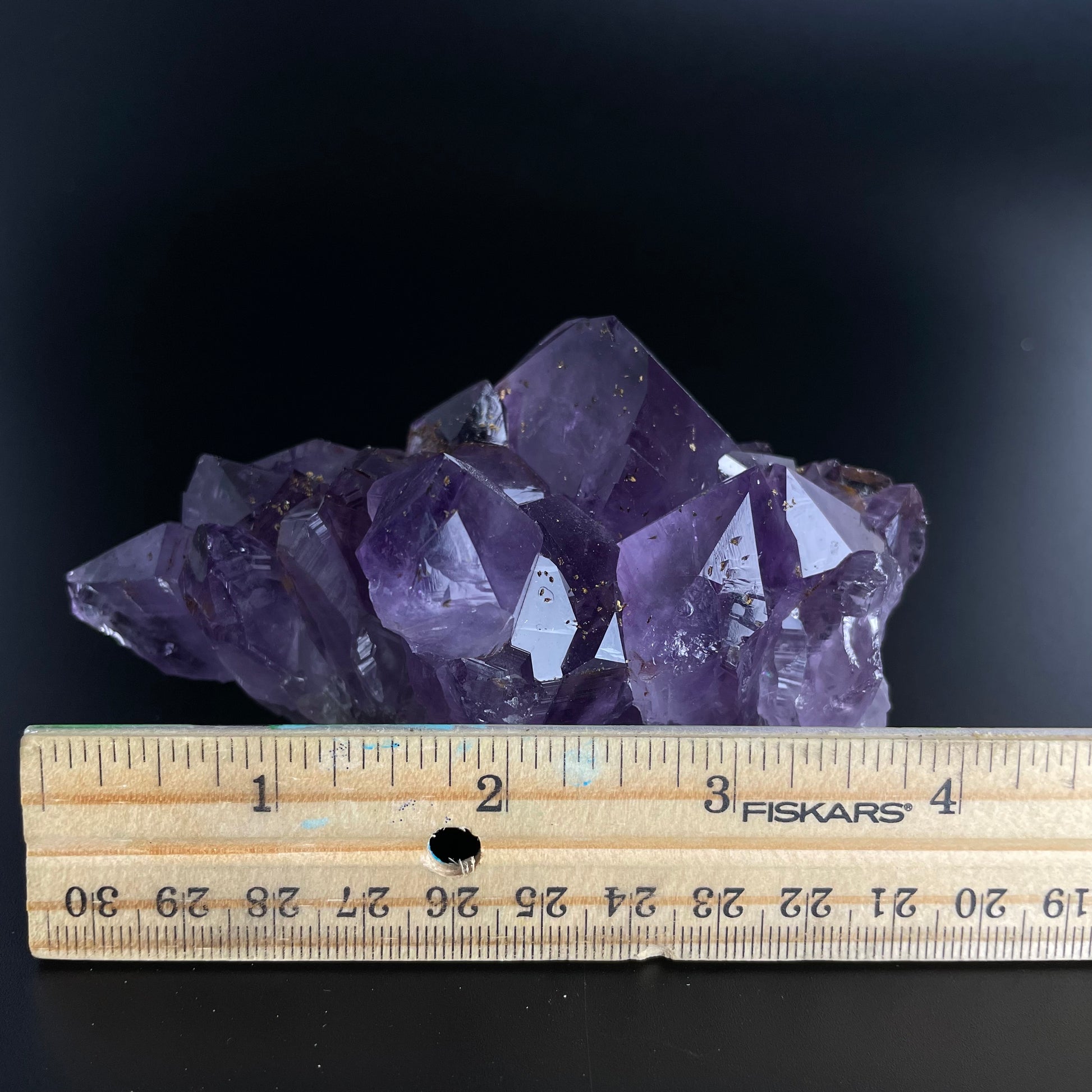 Amethyst cluster with brilliant hues of purple and various sizes of crystal formations.