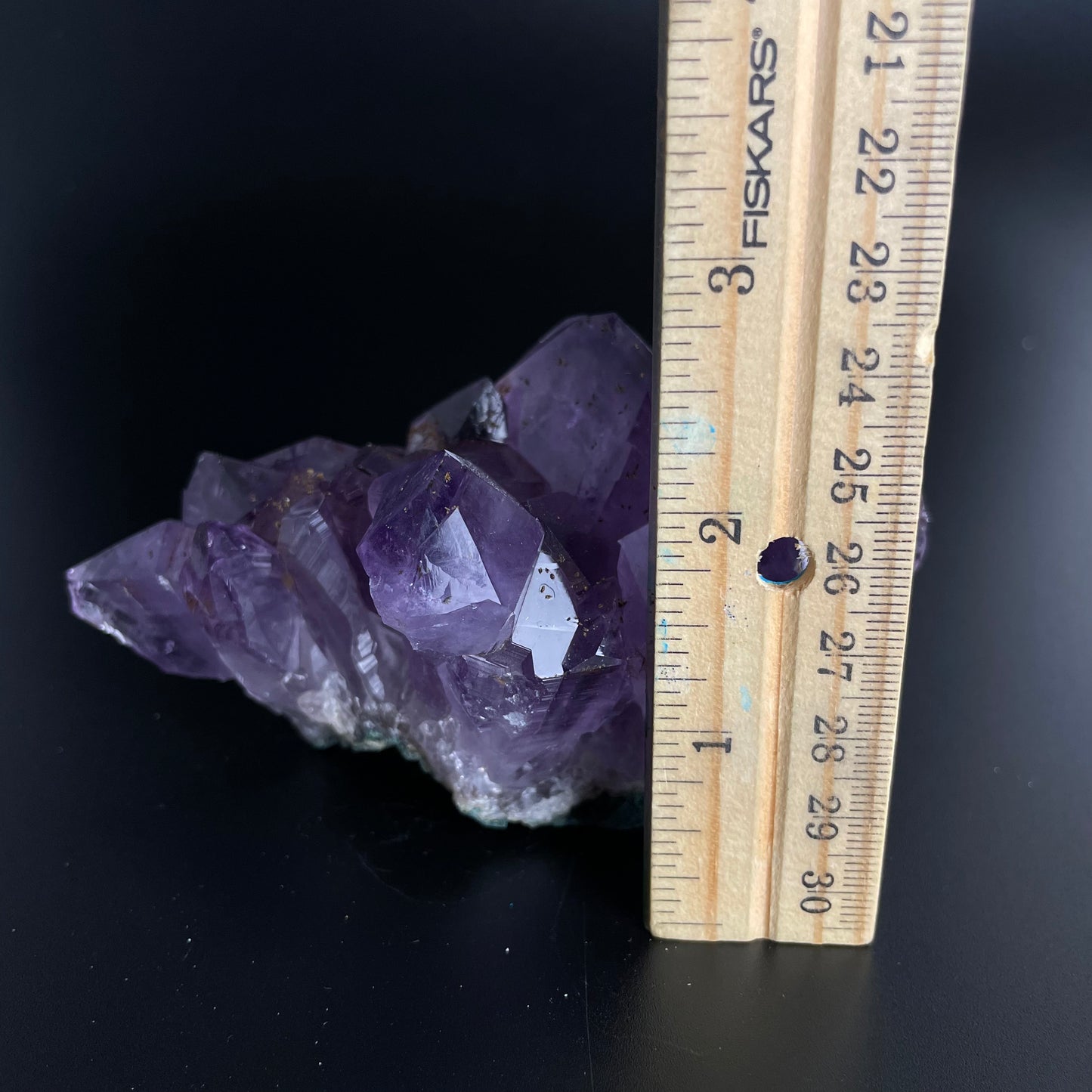 Amethyst cluster with brilliant hues of purple and various sizes of crystal formations.