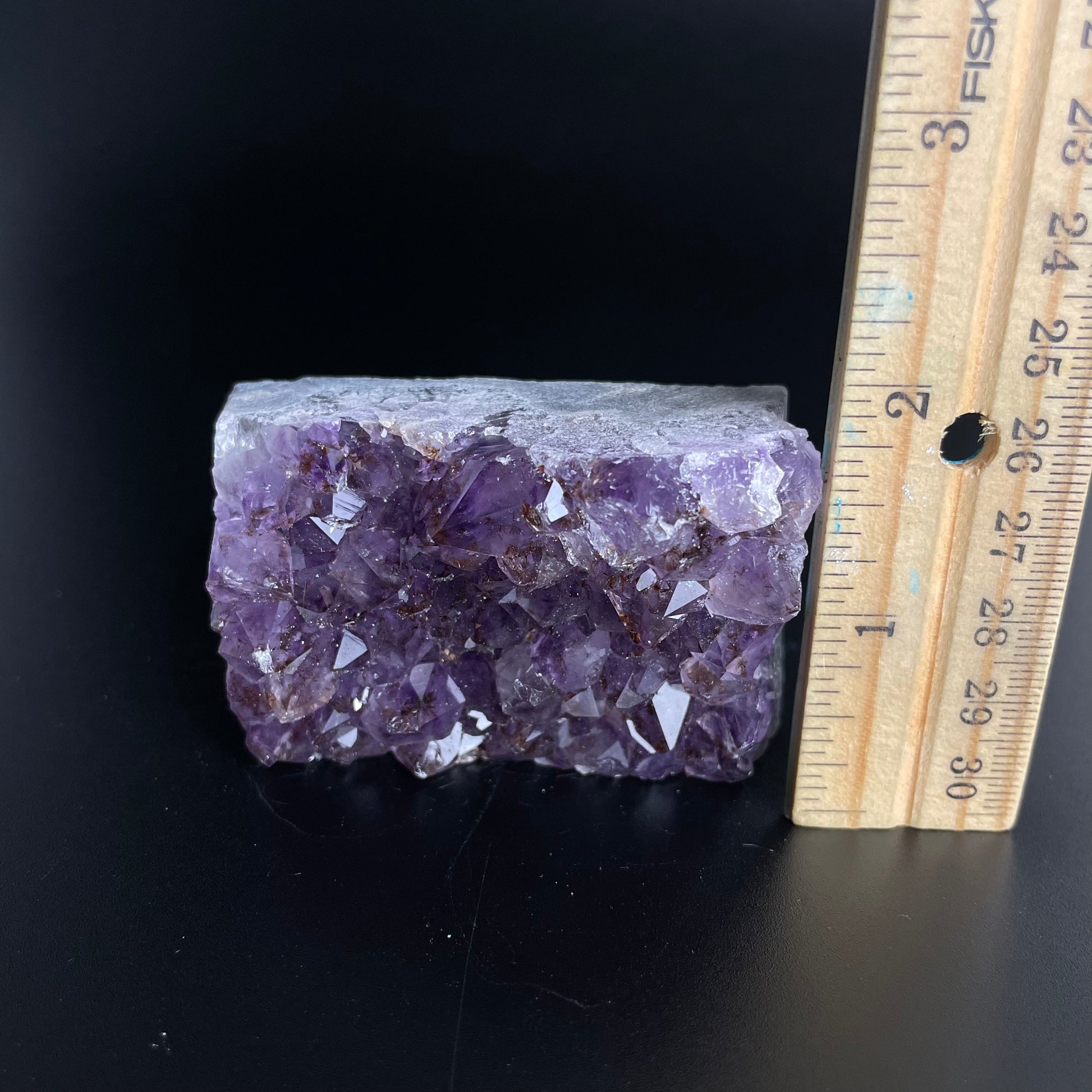 Amethyst cluster with brilliant hues of purple and various sizes of crystal formations.