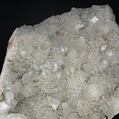 A zeolite cluster with distinctive earth-toned crystal formations.