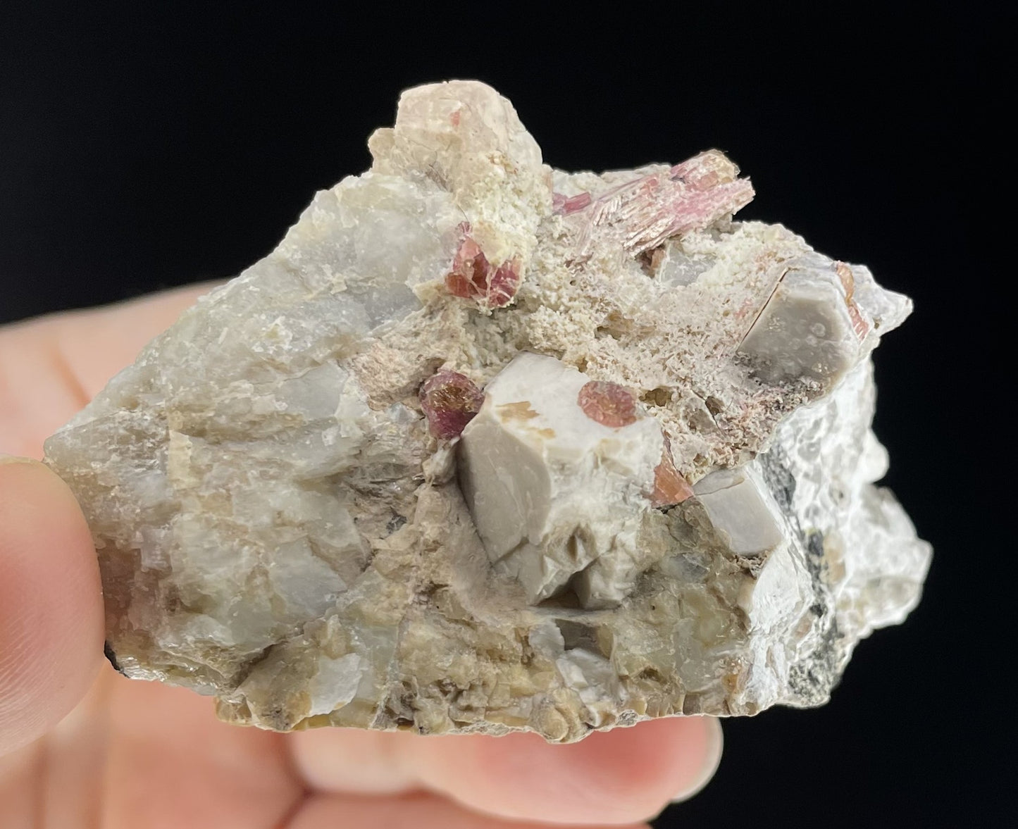 A close-up image of two mineral specimens featuring creamy Orthoclase crystals intergrown with clear quartz and dark tourmaline, showcasing a striking blend of textures and colors.