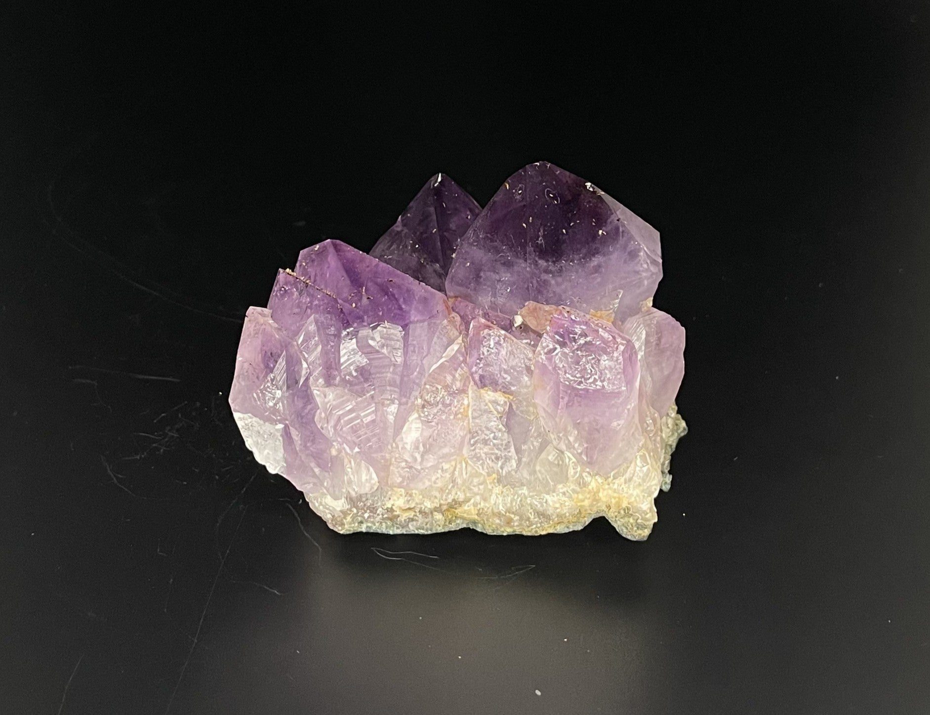 Amethyst cluster with brilliant hues of purple and various sizes of crystal formations