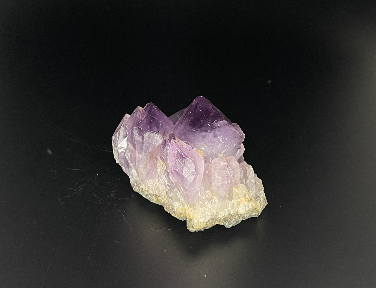 Amethyst cluster with brilliant hues of purple and various sizes of crystal formations