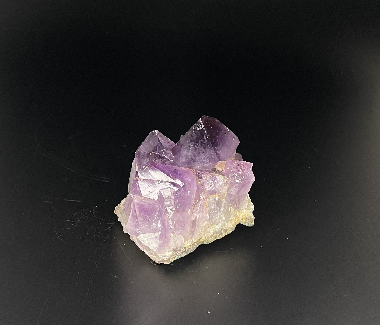 Amethyst cluster with brilliant hues of purple and various sizes of crystal formations