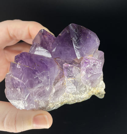 Amethyst cluster with brilliant hues of purple and various sizes of crystal formations