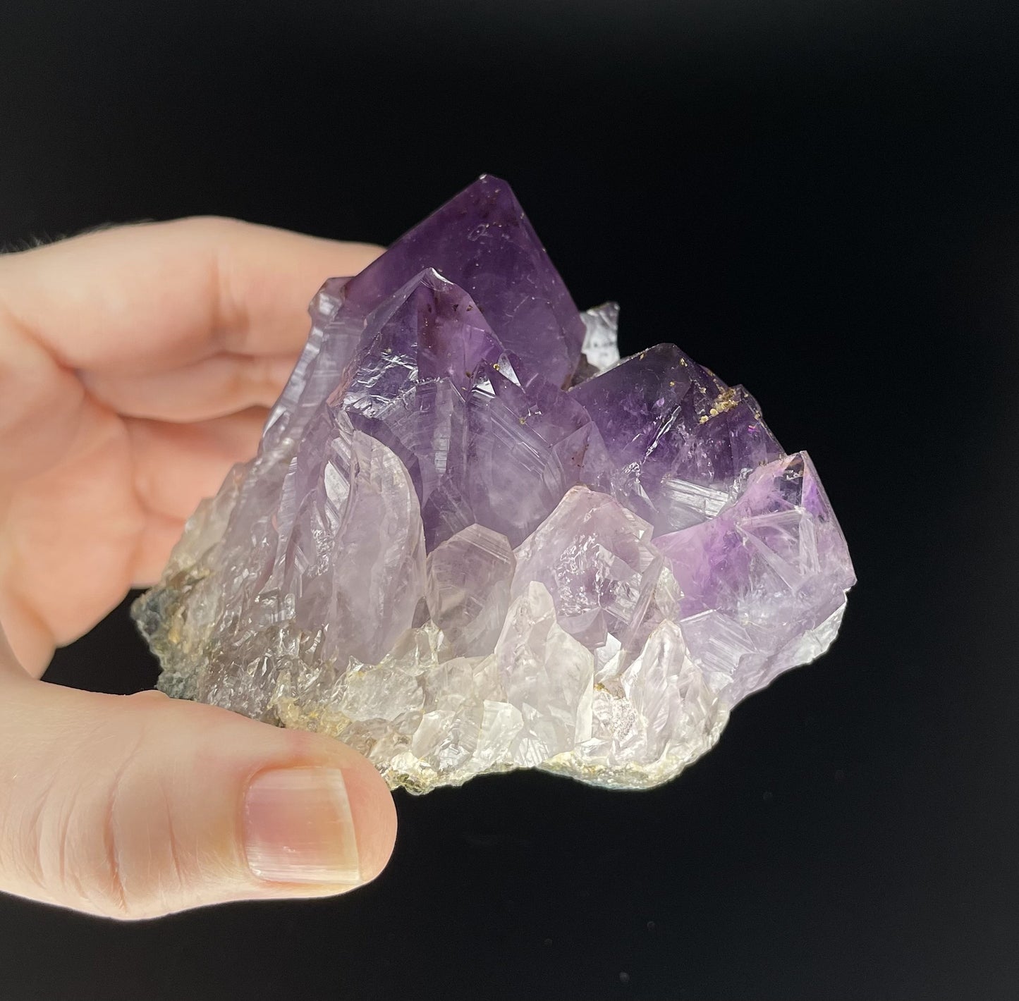 Amethyst cluster with brilliant hues of purple and various sizes of crystal formations