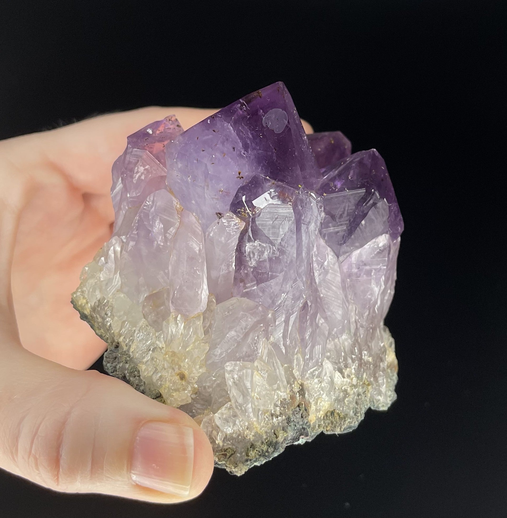 Amethyst cluster with brilliant hues of purple and various sizes of crystal formations