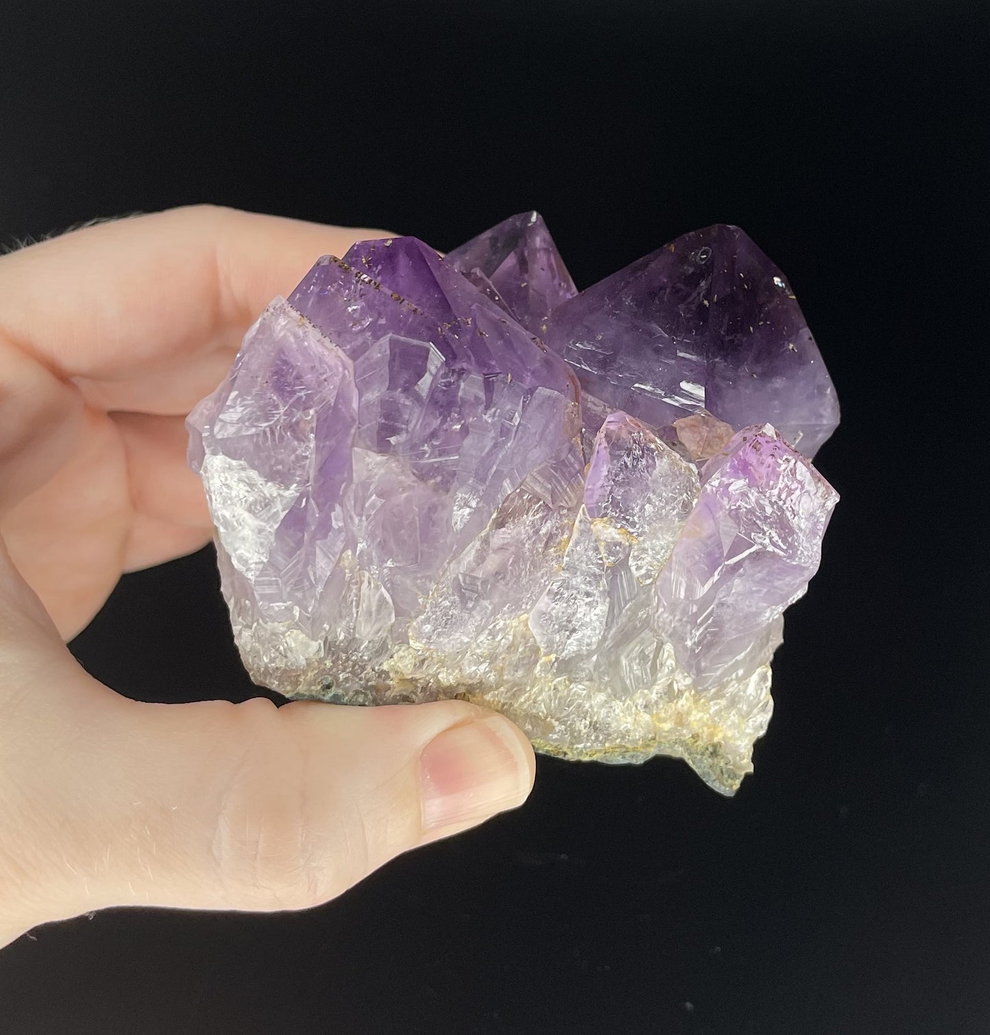 Amethyst cluster with brilliant hues of purple and various sizes of crystal formations