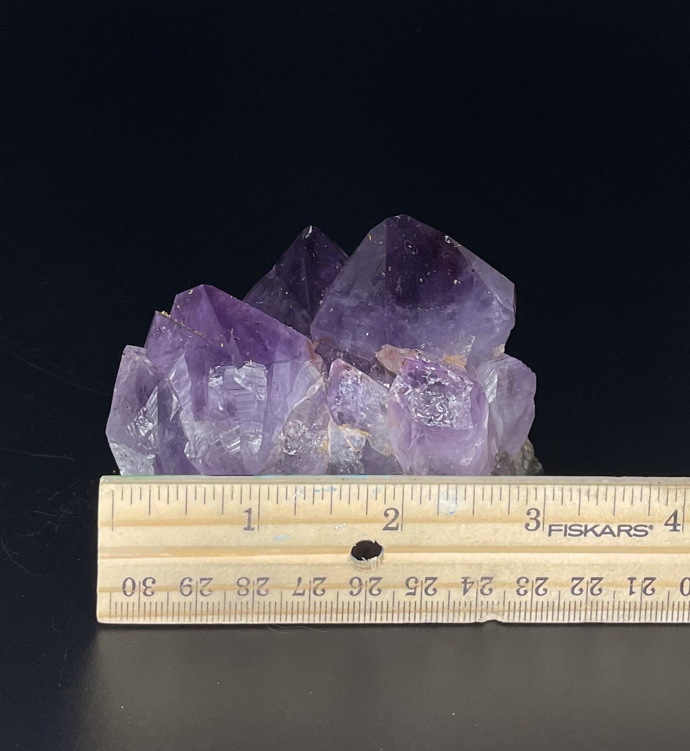 Amethyst cluster with brilliant hues of purple and various sizes of crystal formations