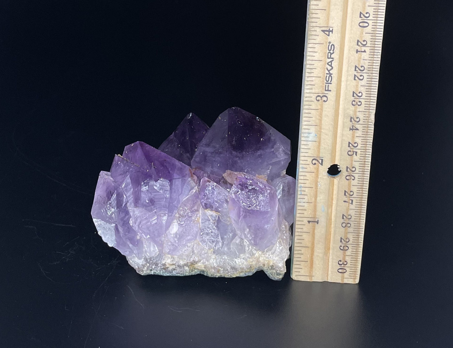 Amethyst cluster with brilliant hues of purple and various sizes of crystal formations