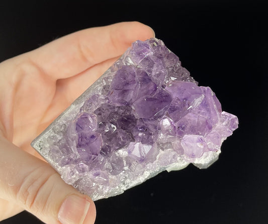 Amethyst cluster with brilliant hues of purple and various sizes of crystal formations