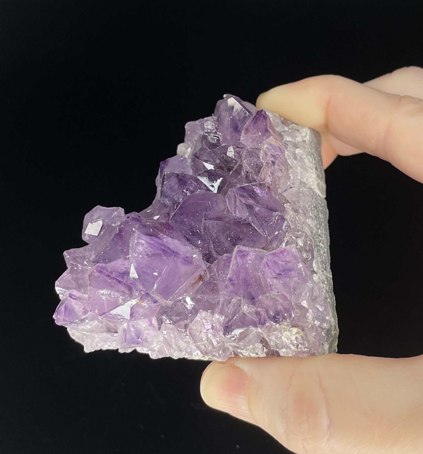 Amethyst cluster with brilliant hues of purple and various sizes of crystal formations