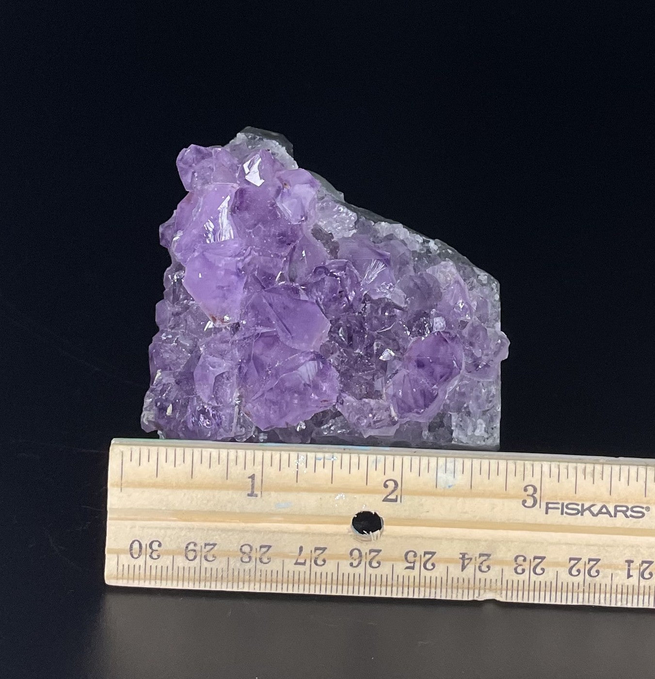 Amethyst cluster with brilliant hues of purple and various sizes of crystal formations