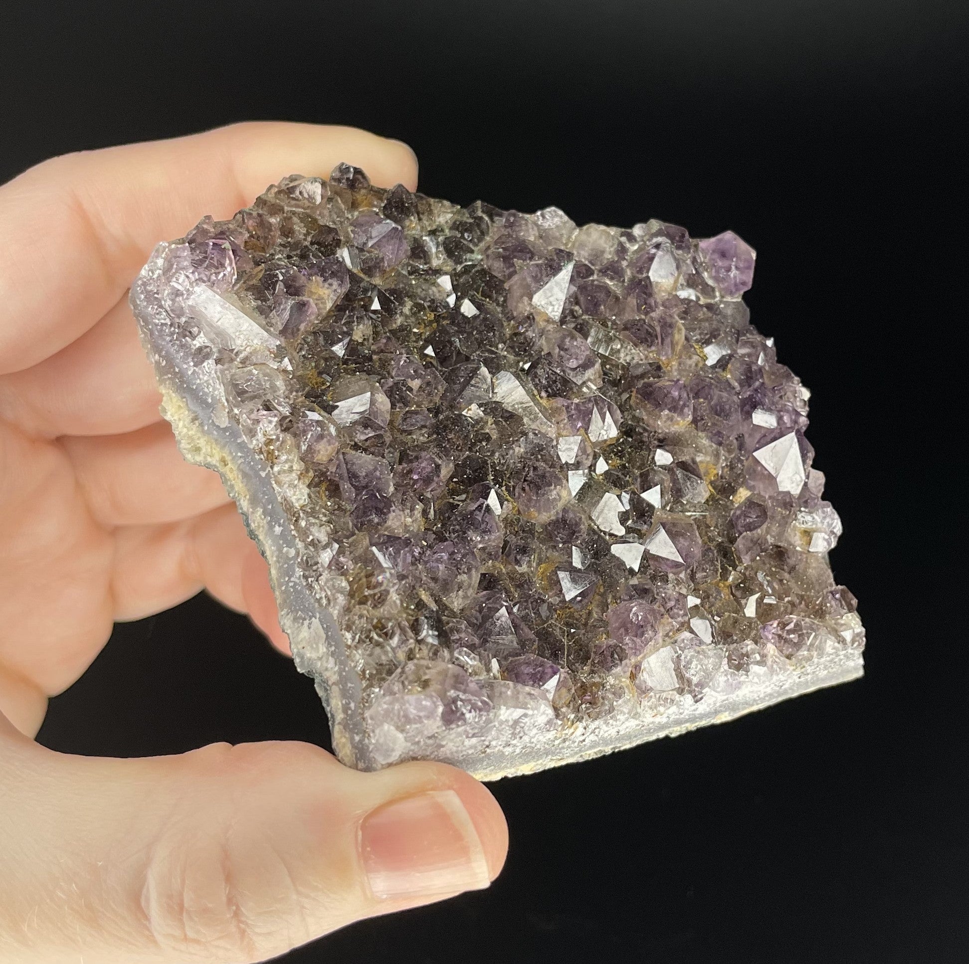 Amethyst cluster with brilliant hues of purple and various sizes of crystal formations