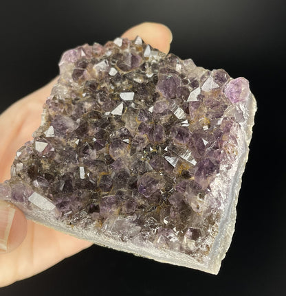 Amethyst cluster with brilliant hues of purple and various sizes of crystal formations