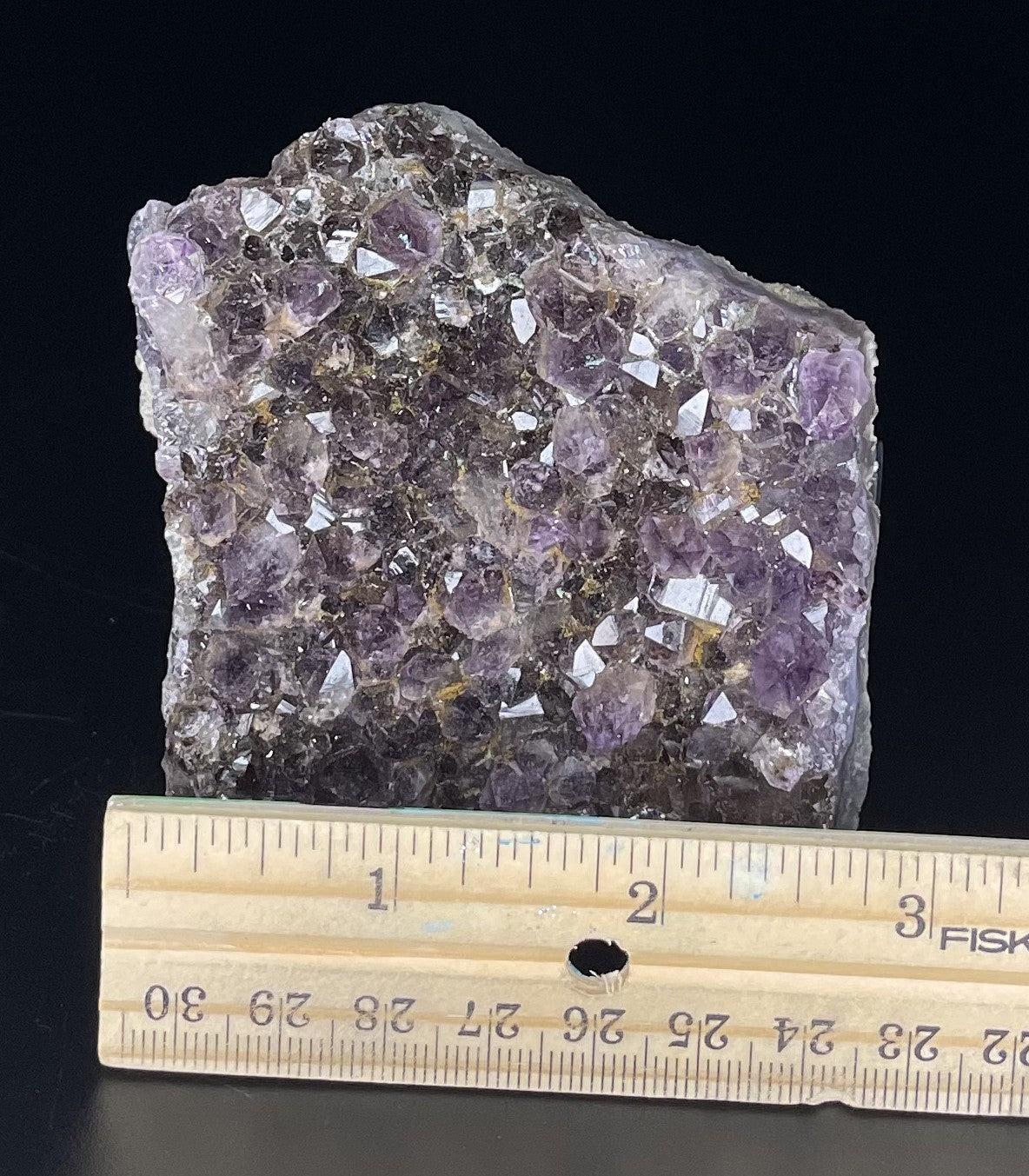 Amethyst cluster with brilliant hues of purple and various sizes of crystal formations