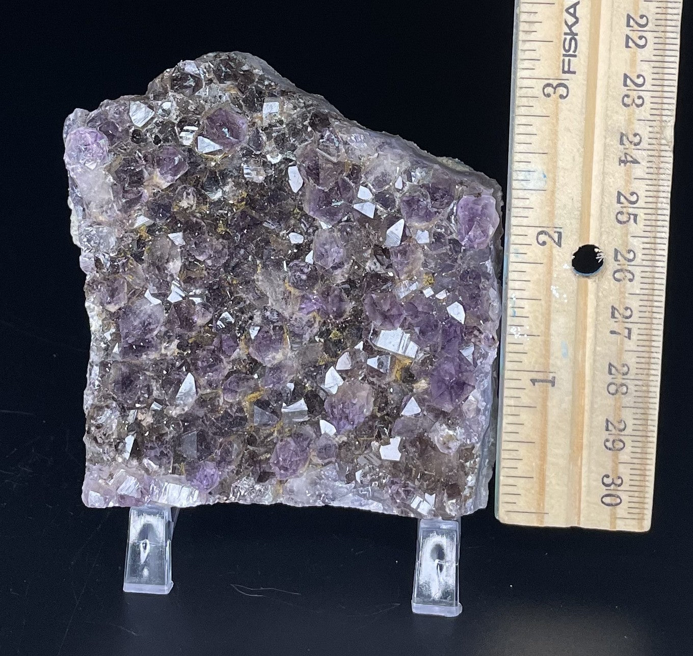 Amethyst cluster with brilliant hues of purple and various sizes of crystal formations