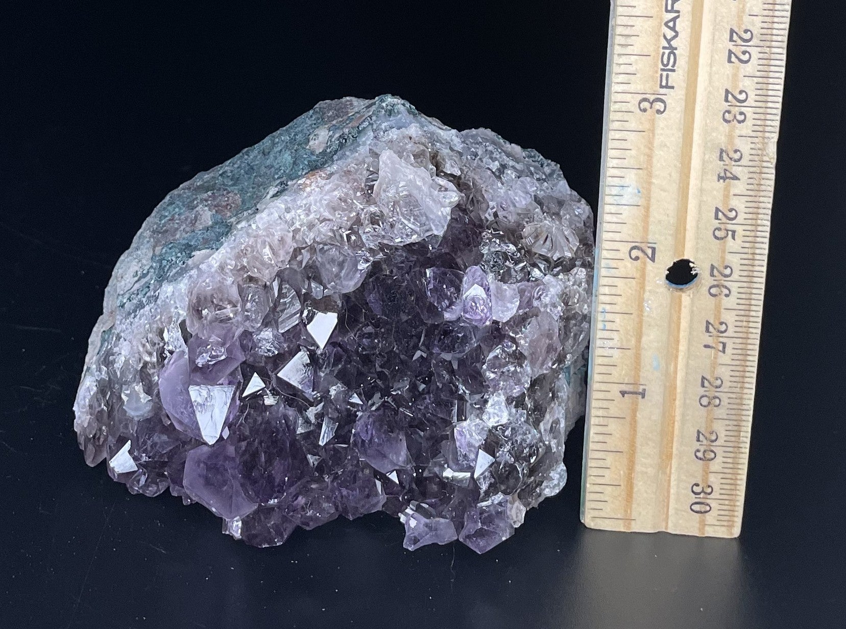 Amethyst cluster with brilliant hues of purple and various sizes of crystal formations