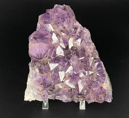 Amethyst cluster with brilliant hues of purple and various sizes of crystal formations