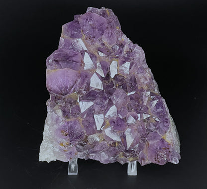 Amethyst cluster with brilliant hues of purple and various sizes of crystal formations.