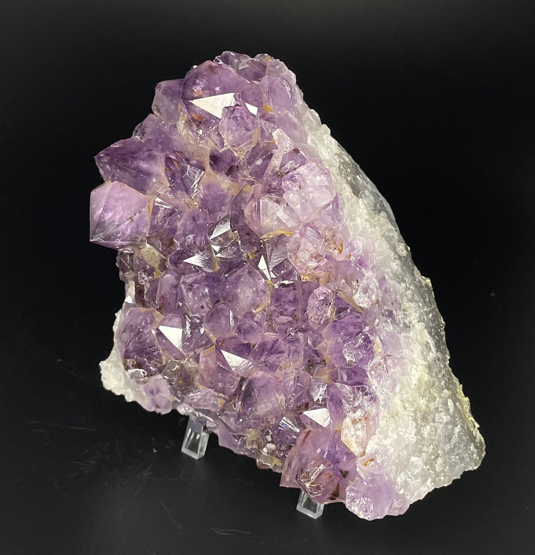 Amethyst cluster with brilliant hues of purple and various sizes of crystal formations