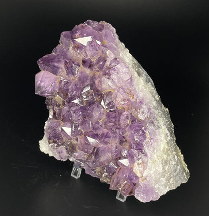 Amethyst cluster with brilliant hues of purple and various sizes of crystal formations