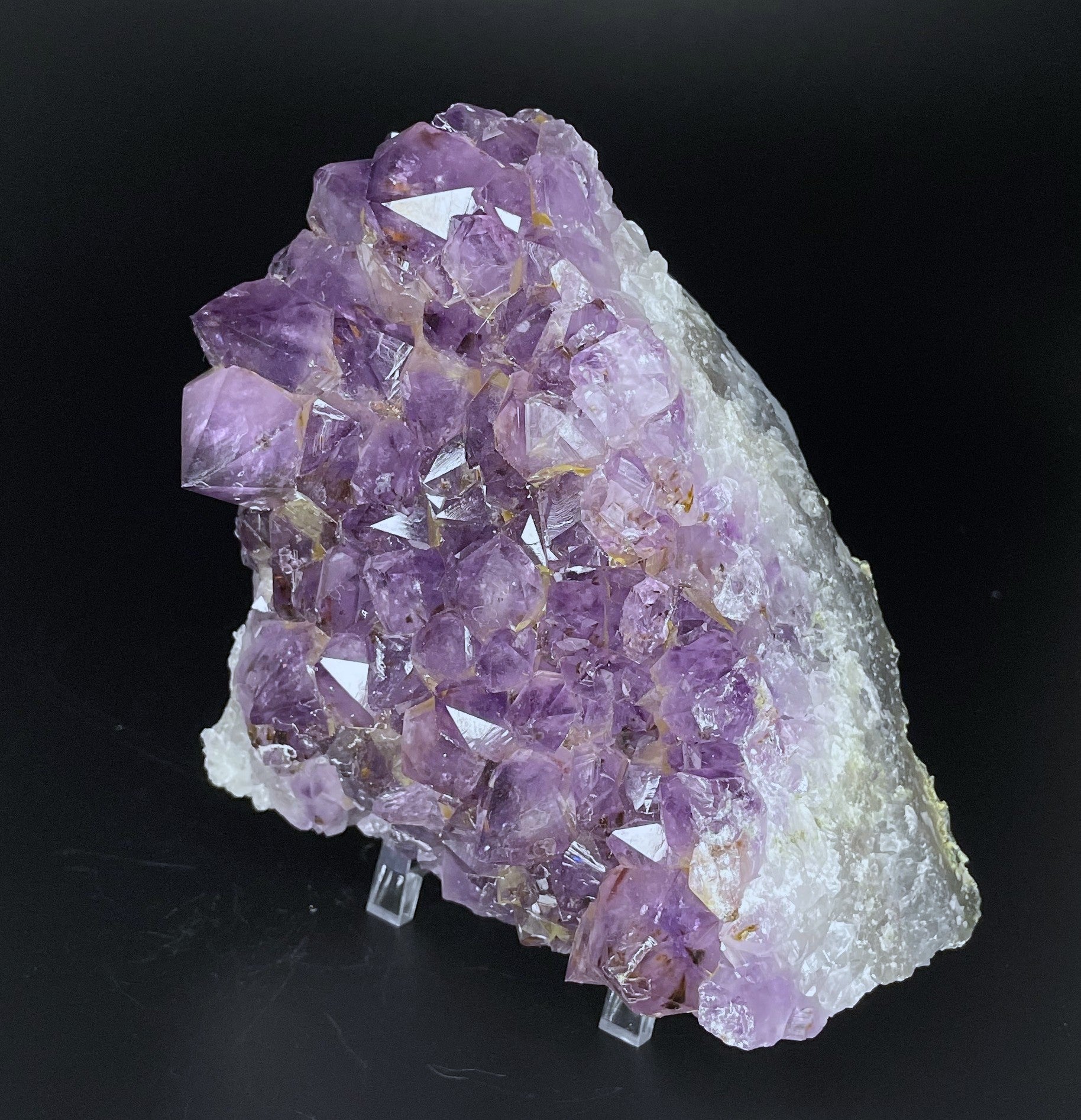 Amethyst cluster with brilliant hues of purple and various sizes of crystal formations.