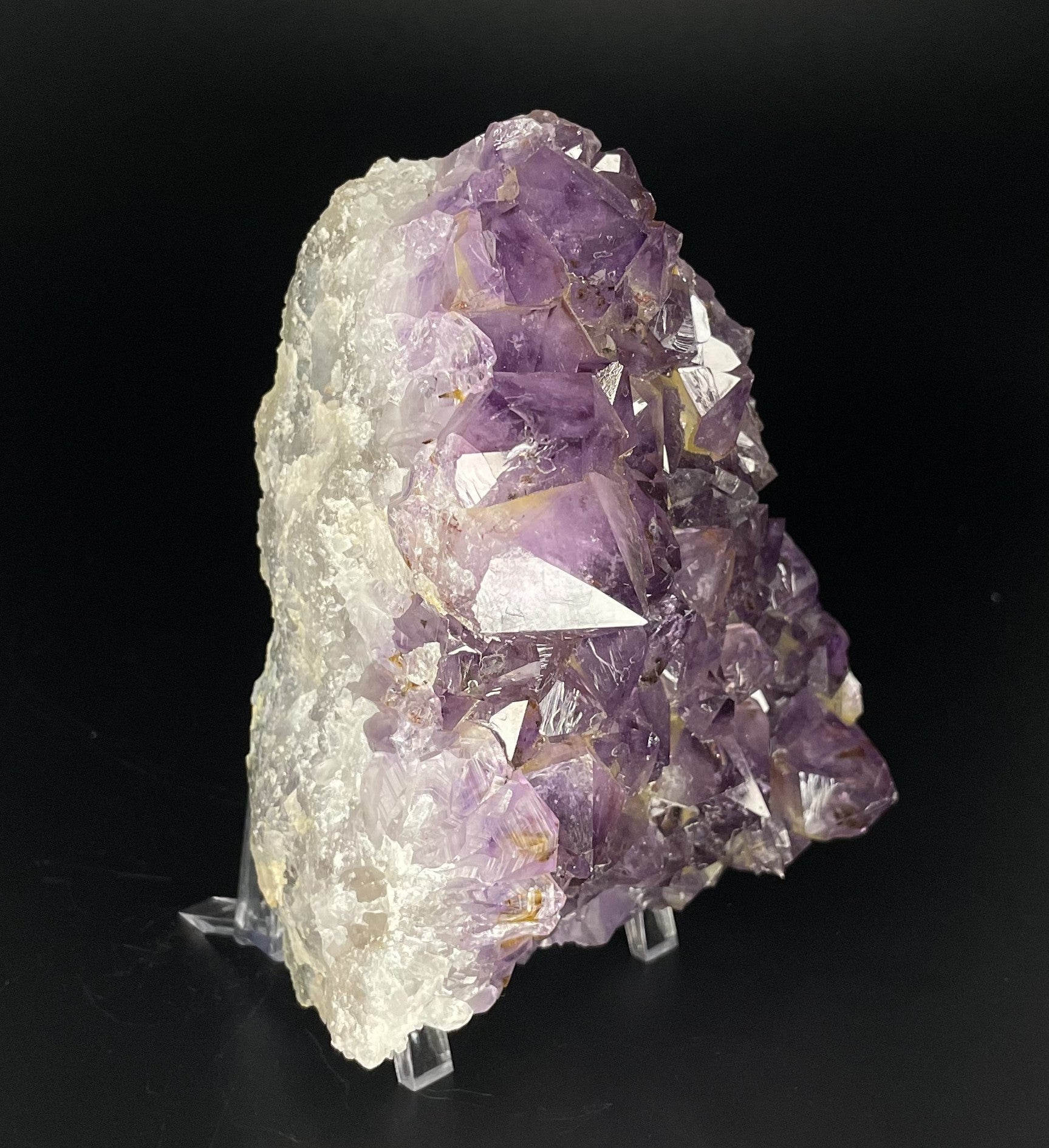 Amethyst cluster with brilliant hues of purple and various sizes of crystal formations