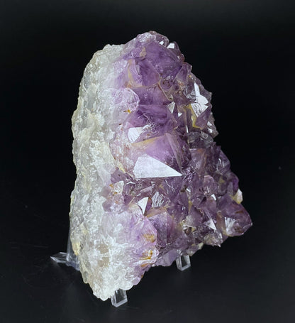 Amethyst cluster with brilliant hues of purple and various sizes of crystal formations.