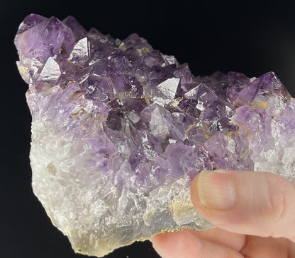 Amethyst cluster with brilliant hues of purple and various sizes of crystal formations